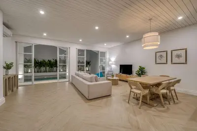 a living room with a table and a couch at Brand New 4BR Colonial Retreat in Berawa, Canggu in Canggu
