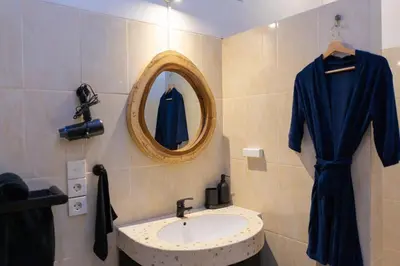 a bathroom with a sink and a mirror at Peaceful 2br with pool & garden in Seminyak