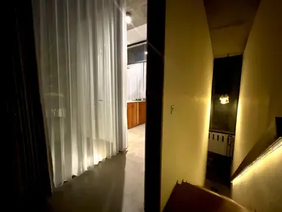 a hallway with a window with white curtains at Teras by Tamora in Badung