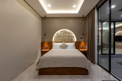 a bedroom with a bed and a large window at Sandat Villa 123 in Canggu