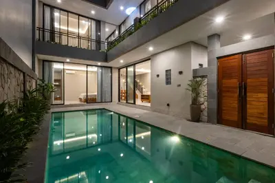 an indoor swimming pool in a house at Sandat Villa 123 in Canggu