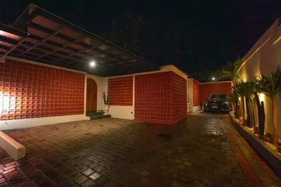 a house with red brick walls and a parking lot at Zahra Villas in Nusa Dua