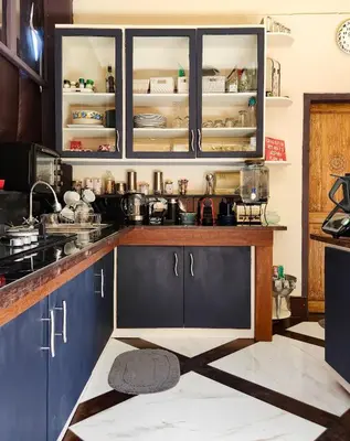 a kitchen with blue cabinets and a counter top at Serai House 2BR Cozy Kerobokan Home in Kerobokan