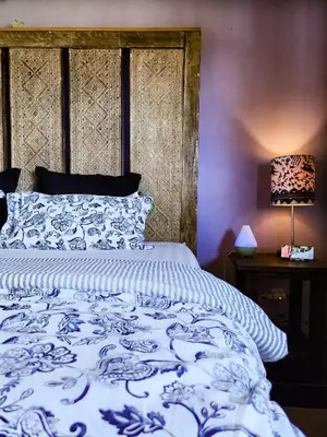 a bedroom with a blue and white bed and a lamp at Serai House 2BR Cozy Kerobokan Home in Kerobokan
