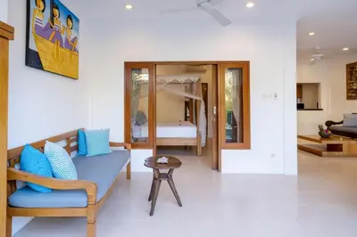 a living room with a couch and a bedroom at Genta- Petitenget 2BR villa, walk to beach! in Seminyak