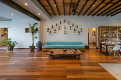 a living room with a blue couch and a table at Villa Java by DreamAwayBali in Seminyak