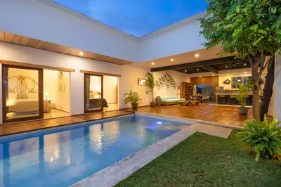 a swimming pool in the middle of a house at Villa Java by DreamAwayBali in Seminyak
