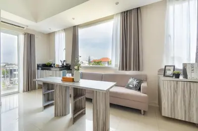 a living room with a table and a couch at Bali Bustle Kuta Coliving & Coworking Space in Legian