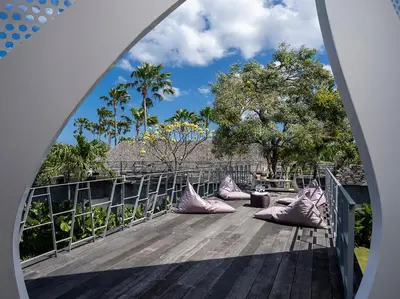 a view from an archway of a deck with pillows at Villa Issi in Seminyak