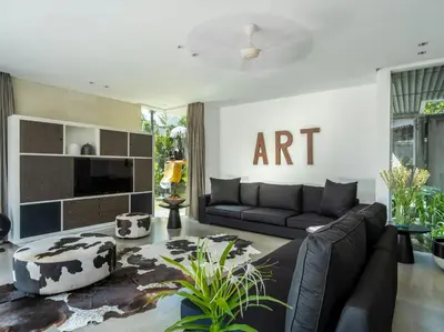 a living room with a couch and a tv at Villa Issi in Seminyak