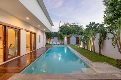 an image of a swimming pool in the backyard of a house at Villa Nuga By DreamAwayBali in Seminyak