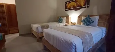 a hotel room with two beds in a room at Kubunaku Sanur Bali in Sanur
