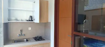 a kitchen with a sink and a counter top at Kubunaku Sanur Bali in Sanur