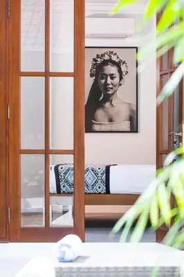 a glass door with a picture of a woman at Saro - Top location near Potato Head, walk everywhere! in Seminyak