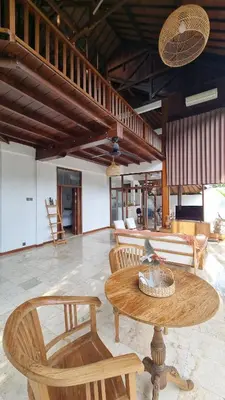 a living room with a table and chairs at 2 Minutes Walk to the Beach 3BR Retreat Villa in Canggu