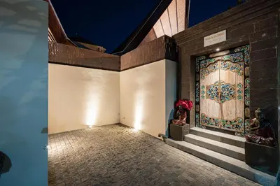 a building with a large door with a mural on it at Villa Dijabu in Kuta
