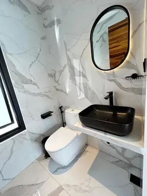 a white bathroom with a sink and a toilet at Villa Kawis Seminyak in Seminyak