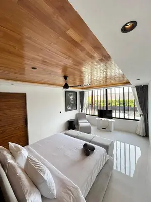 a bedroom with a large bed and a couch at Villa Kawis Seminyak in Seminyak