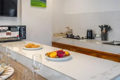 a kitchen with two plates of fruit on a counter at A9 - Exclusive 3-Bedroom Villa in Seminyak with a Rooftop Paradise in Kerobokan