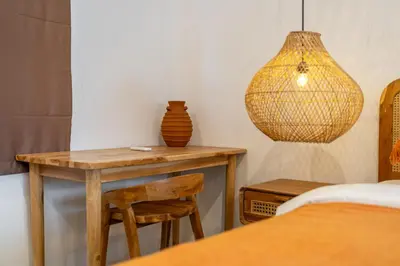 a wooden table with a vase and a lamp at A9 - Exclusive 3-Bedroom Villa in Seminyak with a Rooftop Paradise in Kerobokan