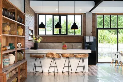 a kitchen with a counter with stools at Villa N'Zo By DreamAwayBali in Seminyak