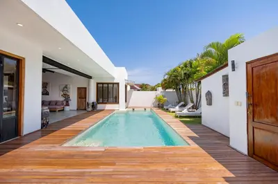 a swimming pool in the middle of a house at Villa N'Zo By DreamAwayBali in Seminyak