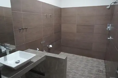 a bathroom with a sink and a shower at 5 bedroom villa in kuta with 2 swimingpool in Kuta