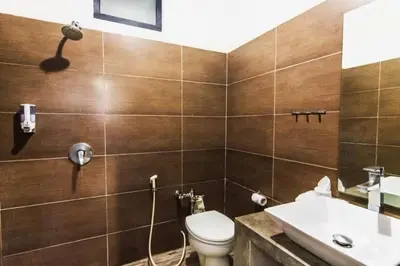 a bathroom with a toilet and a sink at 5 bedroom villa in kuta with 2 swimingpool in Kuta