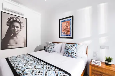 a bedroom with a bed and a picture on the wall at Ti - 1BR pool villa in the heart of Seminyak in Seminyak