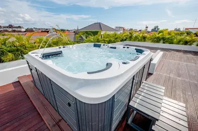 a hot tub on the roof of a house at Villa Kamawis Seminyak in Seminyak