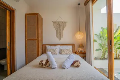 a bedroom with a bed with two towels on it at Sunrise Oasis - 2BR Villa in Kerobokan in Kerobokan