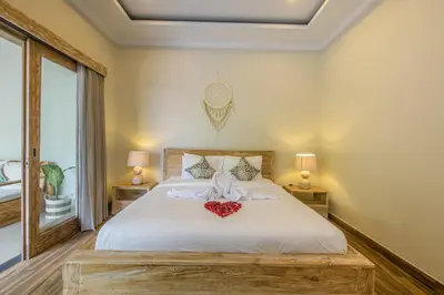 a bedroom with a bed with a heart on it at Dion Villas Berawa only 5 Minutes by scooter to Finns beach club in Canggu