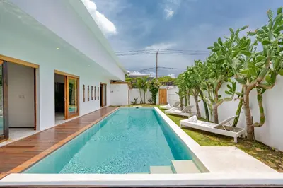 an indoor swimming pool in a house at Villa Wuizy By DreamAwayBali in Seminyak