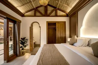 a bedroom with a large bed in a room at Villa Advaya by Maheswara in Seminyak