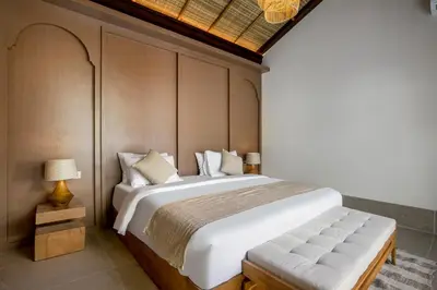 a bedroom with a large white bed in a room at Villa Advaya by Maheswara in Seminyak