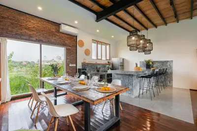 a dining room and kitchen with a table and chairs at Villa Wampu By DreamAwayBali in Seminyak