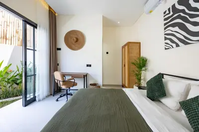 a bedroom with a large bed and a desk at Pool Garden Private 2BR Villa - 10 min to Finns Beach Club in Canggu