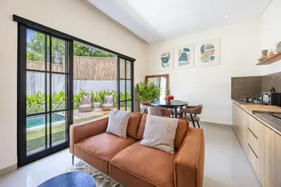 a living room with a couch and a table at Pool Garden Private 2BR Villa - 10 min to Finns Beach Club in Canggu