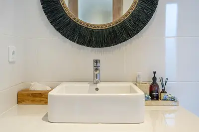 a bathroom with a white sink and a mirror at La Palma - Spacious 2BR Villa with Large Pool in Canggu in Canggu