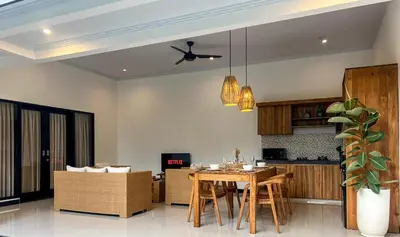 a kitchen and living room with a table and chairs at Villa D Canggu in Canggu