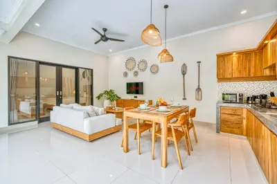 a kitchen and living room with a table and a couch at Villa D Canggu in Canggu
