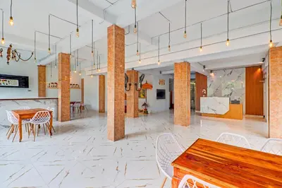 a room with a table and chairs and a table and tablesktop at Townhouse Oak Legian Near Kuta Beach Formerly Sayang Maha Merta in Legian