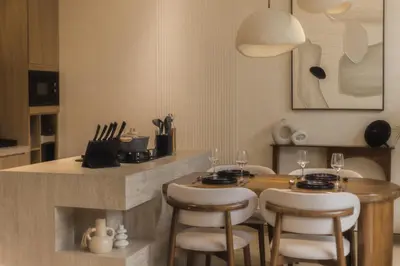 a kitchen with a table and chairs and a counter at CAVO Villa in Seminyak
