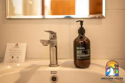 a bottle of soap sitting on top of a sink at A&R4 Villa - by Unicorn Villas Bali in Seminyak