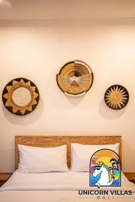 a bedroom with three clocks on the wall and a bed at A&R4 Villa - by Unicorn Villas Bali in Seminyak