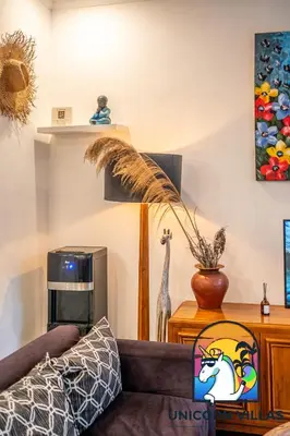 a living room with a couch and a giraffe on a shelf at A&R4 Villa - by Unicorn Villas Bali in Seminyak