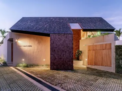 a building with a black roof on a street at House of Winds Complex - Luxury 6BR Tropical Retreat - 2x3BR Villas near Canggu in Kerobokan