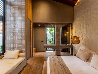 a bedroom with two beds and a desk at House of Winds Complex - Luxury 6BR Tropical Retreat - 2x3BR Villas near Canggu in Kerobokan