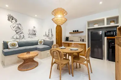 a kitchen and living room with a table and a couch at NEW! Villa Theo - 1BR Villa in Kerobokan in Seminyak