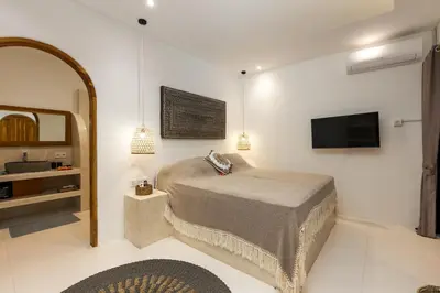 a bedroom with a bed and a flat screen tv at NEW! Villa Theo - 1BR Villa in Kerobokan in Seminyak